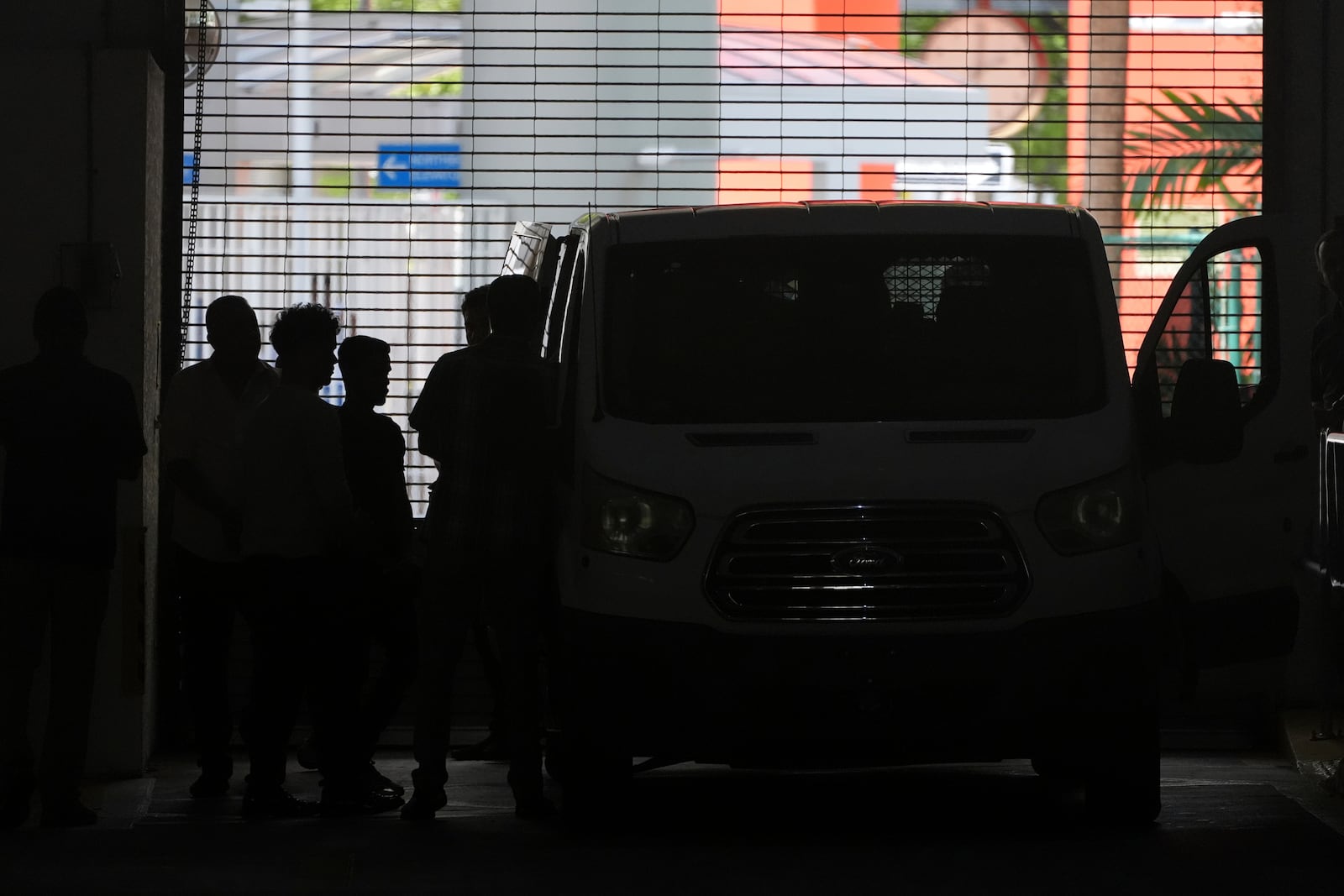 Plainclothes agents from U.S. Immigration and Customs Enforcement load people detained at the Miami Immigration Court into a Department of Homeland Security van in Miami, on Wednesday, May 21, 2025. (AP Photo/Rebecca Blackwell)