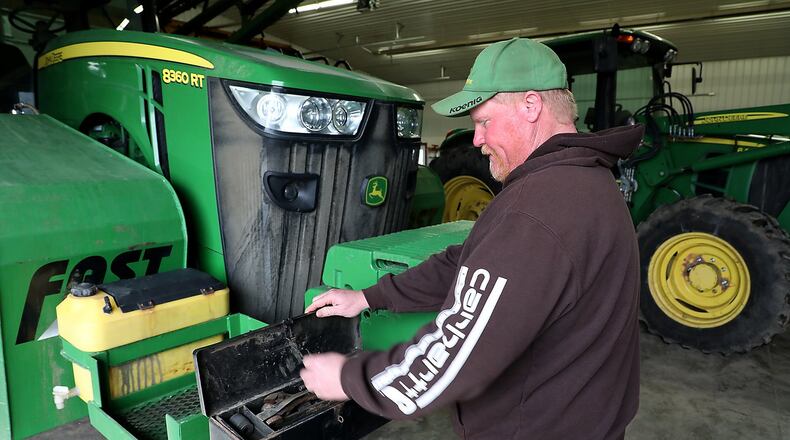 Clark County farmer, Brian Harbage, works on his farm equipment as he waits for the rain to stop so he can get in the fields to plant Tuesday, April 24, 2018. Bill Lackey/Staff
