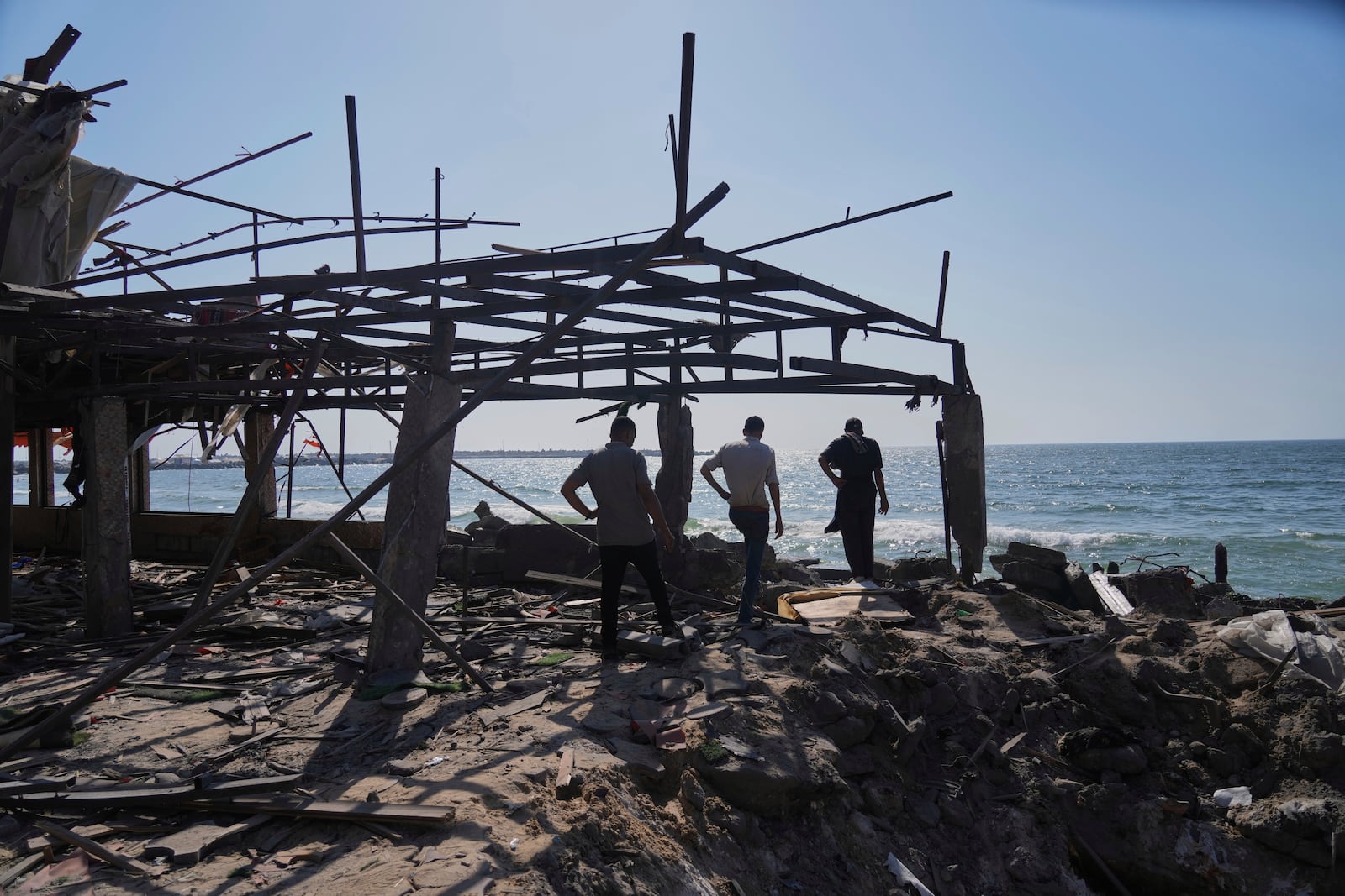 Palestinians check an area of a cafe that was damaged in an Israeli strike, Gaza City, Monday, June 30, 2025. (AP Photo/Jehad Alshrafi)