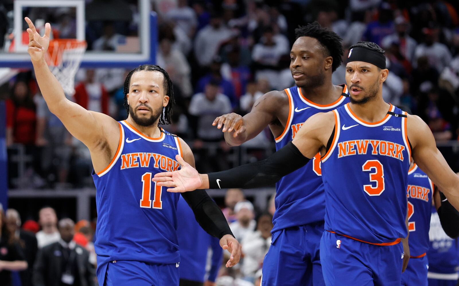 New York Knicks guard Jalen Brunson (11) celebrates with forward OG Anunoby, center, and guard Josh Hart (3) after scoring the winning basket in a win over the Detroit Pistons in Game 6 of an NBA basketball first-round playoff series Thursday, May 1, 2025, in Detroit. (AP Photo/Duane Burleson)