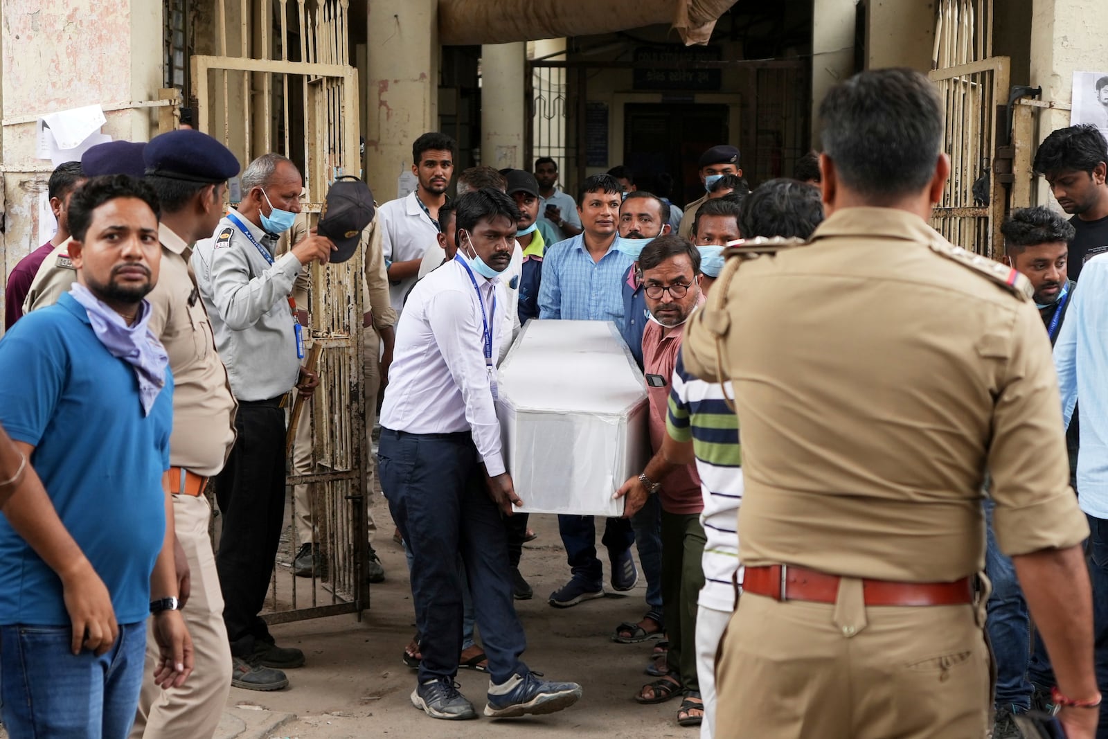 Health workers and volunteers carry the body of a victim of an airplane that crashed in India's northwestern city of Ahmedabad in Gujarat state, on Friday, June 13, 2025. (AP Photo/Ajit Solanki)