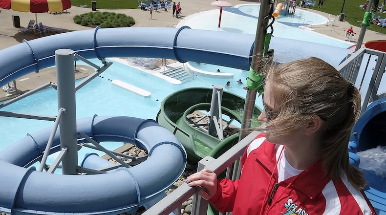Elizabeth Brown, a life guard at Splash Zone in Springfield, looks out of the pool as she waits for someone to go down the water slides Monday. Bill Lackey/Staff