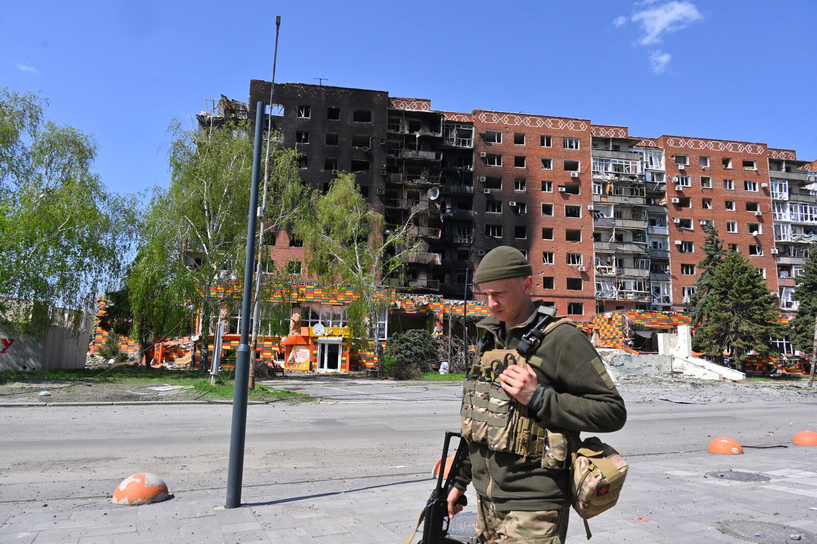 A Ukrainian soldier walks past damaged buildings in central Pokrovsk, the site of the heaviest battles with the Russian troops in the Donetsk region, Ukraine, Wednesday, April 23, 2025. (AP Photo/Michael Shtekel)