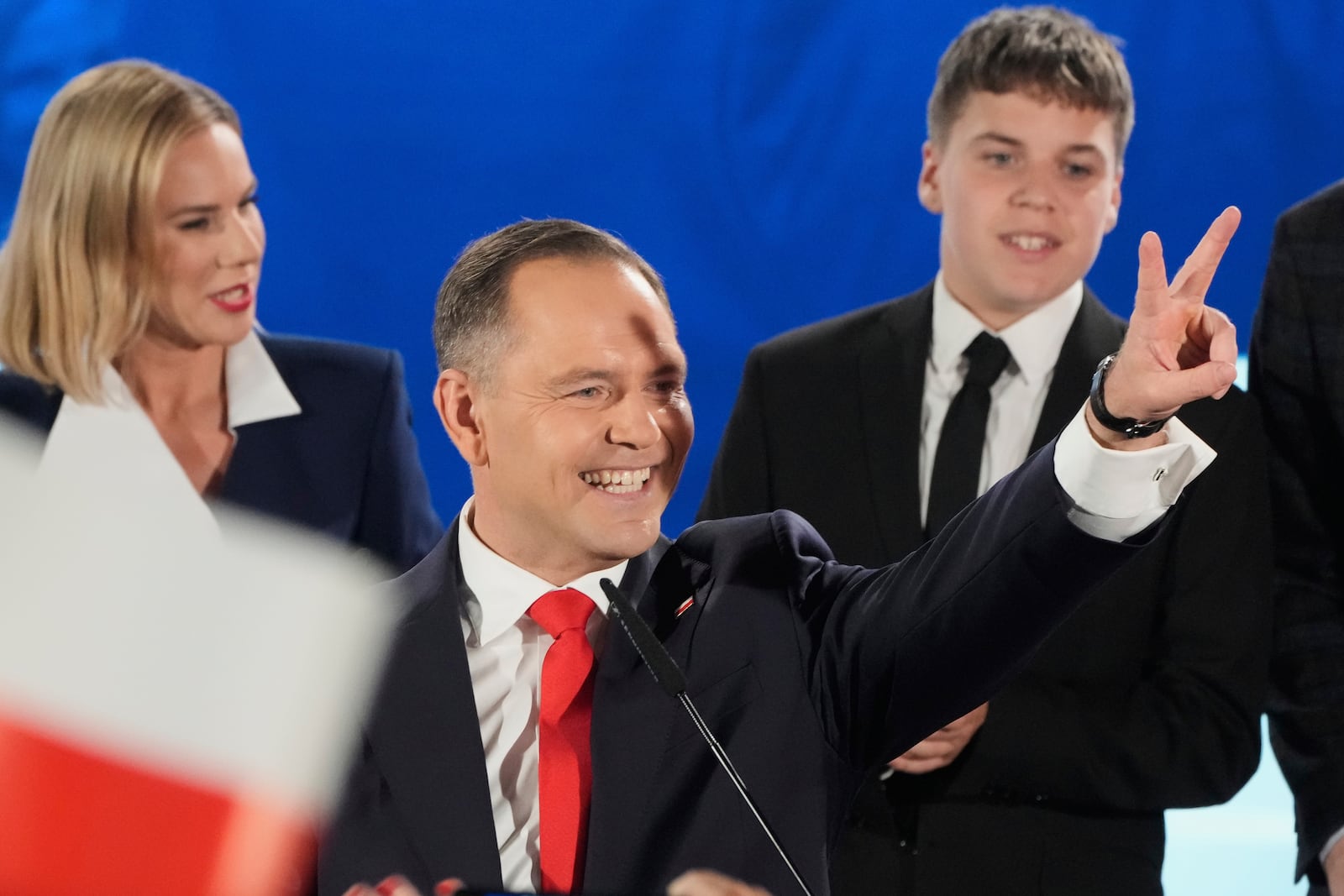 Presidential candidate Karol Nawrocki, a conservative historian backed by the right-wing Law and Justice party greets supporters as he arrives at his headquarters after the presidential election runoff in Warsaw, Poland, Sunday, June 1, 2025. (AP Photo/Czarek Sokolowski)