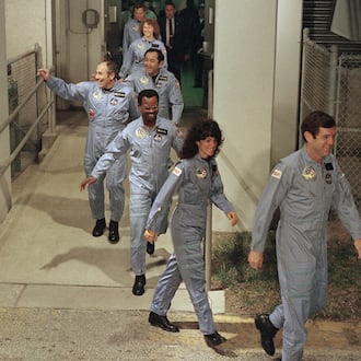 FILE - The crew for the Space Shuttle Challenger flight 51-L leaves their quarters for the launch pad, Jan. 27, 1986, at the Kennedy Space Center in Florida. Front to back are Commander Francis Scobee, Mission Spl. Judith Resnik, Mission Spl. Ronald McNair, Payload Spl. Gregory Jarvis, Mission Spl. Ellison Onizuka, teacher Christa McAuliffe, and pilot Michael Smith. (AP Photo/Steve Helber, File)