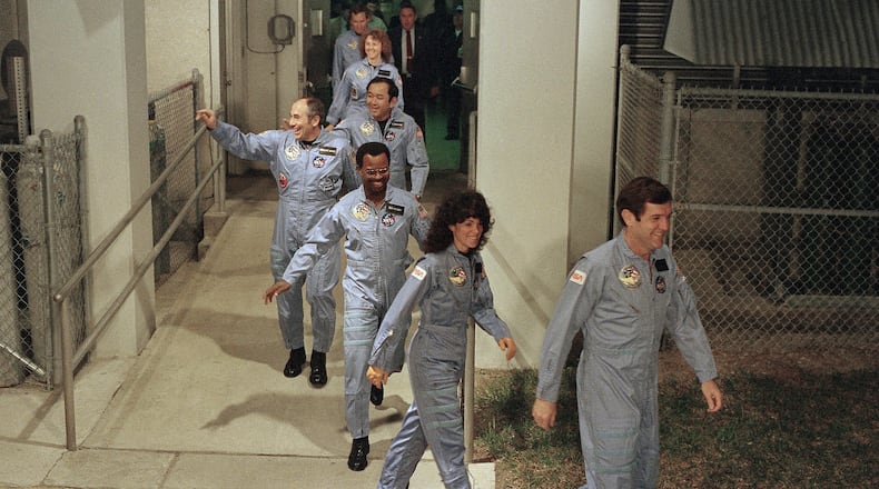 FILE - The crew for the Space Shuttle Challenger flight 51-L leaves their quarters for the launch pad, Jan. 27, 1986, at the Kennedy Space Center in Florida. Front to back are Commander Francis Scobee, Mission Spl. Judith Resnik, Mission Spl. Ronald McNair, Payload Spl. Gregory Jarvis, Mission Spl. Ellison Onizuka, teacher Christa McAuliffe, and pilot Michael Smith. (AP Photo/Steve Helber, File)
