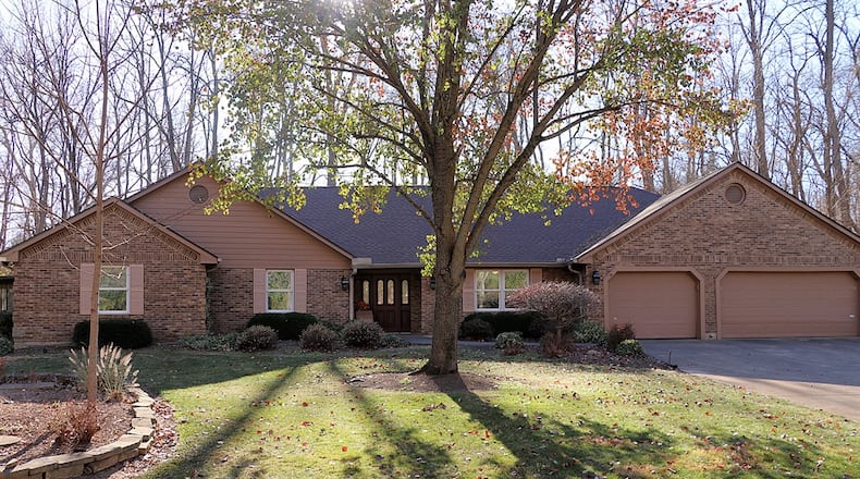 An electronic gate opens to a secluded 3.52-acre property with woods, a creek and tailored lawn that surrounds a brick ranch that has about 3,573 square feet of living space. Contributed photos by Kathy Tyler