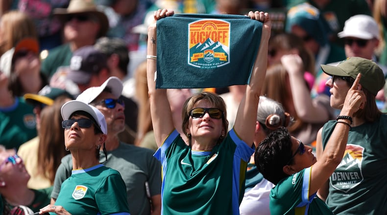A fan holds up a towel for Denver Summit FC in the first half of an NWSL soccer match against the Washington Spirit, Saturday, March 28, 2026, in Denver. (AP Photo/David Zalubowski)