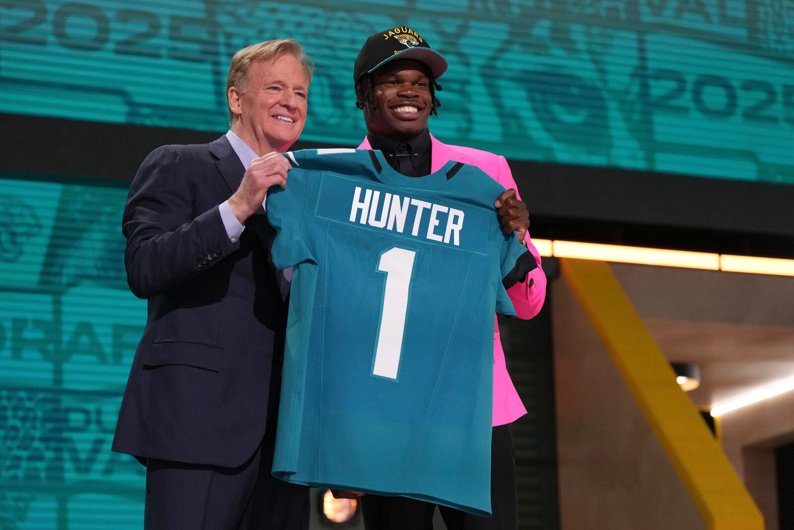 Colorado wide receiver Travis Hunter, right, poses with NFL Commissioner Roger Goodell after being chosen by the Jacksonville Jaguars with the second overall pick during the first round of the NFL football draft, Thursday, April 24, 2025, in Green Bay, Wis. (AP Photo/Jeff Roberson)