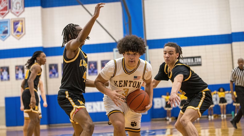 Kenton Ridge High School senior Caleb Hall drives past two Meadowdale defenders during their game on Monday, Feb. 23, 2026 at Xenia High School. The Cougars won 72-52. MICHAEL COOPER / STAFF PHOTO