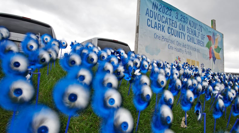 A sea of blue and silver pinwheels whirl in the breeze Wednesday, April 3, 2024 in front of Clark County Job and Family Services for Child Abuse Prevention Month. BILL LACKEY/STAFF