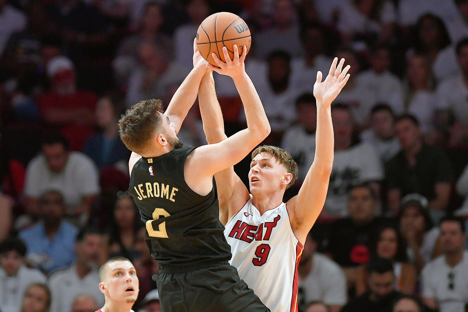 Cleveland Cavaliers guard Ty Jerome (2) shoots over Miami Heat guard Pelle Larsson (9) during the first half in Game 3 of an NBA basketball first-round playoff series, Saturday, April 26, 2025, in Miami. (AP Photo/Michael Laughlin)