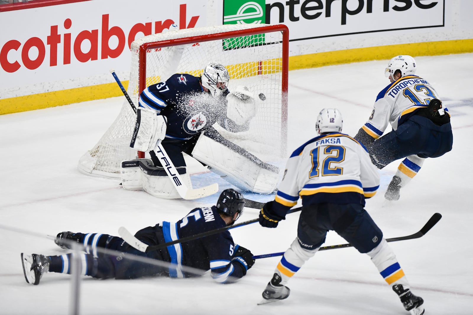 St. Louis Blues' Radek Faksa (12) scores against Winnipeg Jets goaltender Connor Hellebuyck (37) during the second period of Game 7 in an NHL hockey first-round playoff series in Winnipeg, Manitoba, Sunday, May 4, 2025. (Fred Greenslade/The Canadian Press via AP)