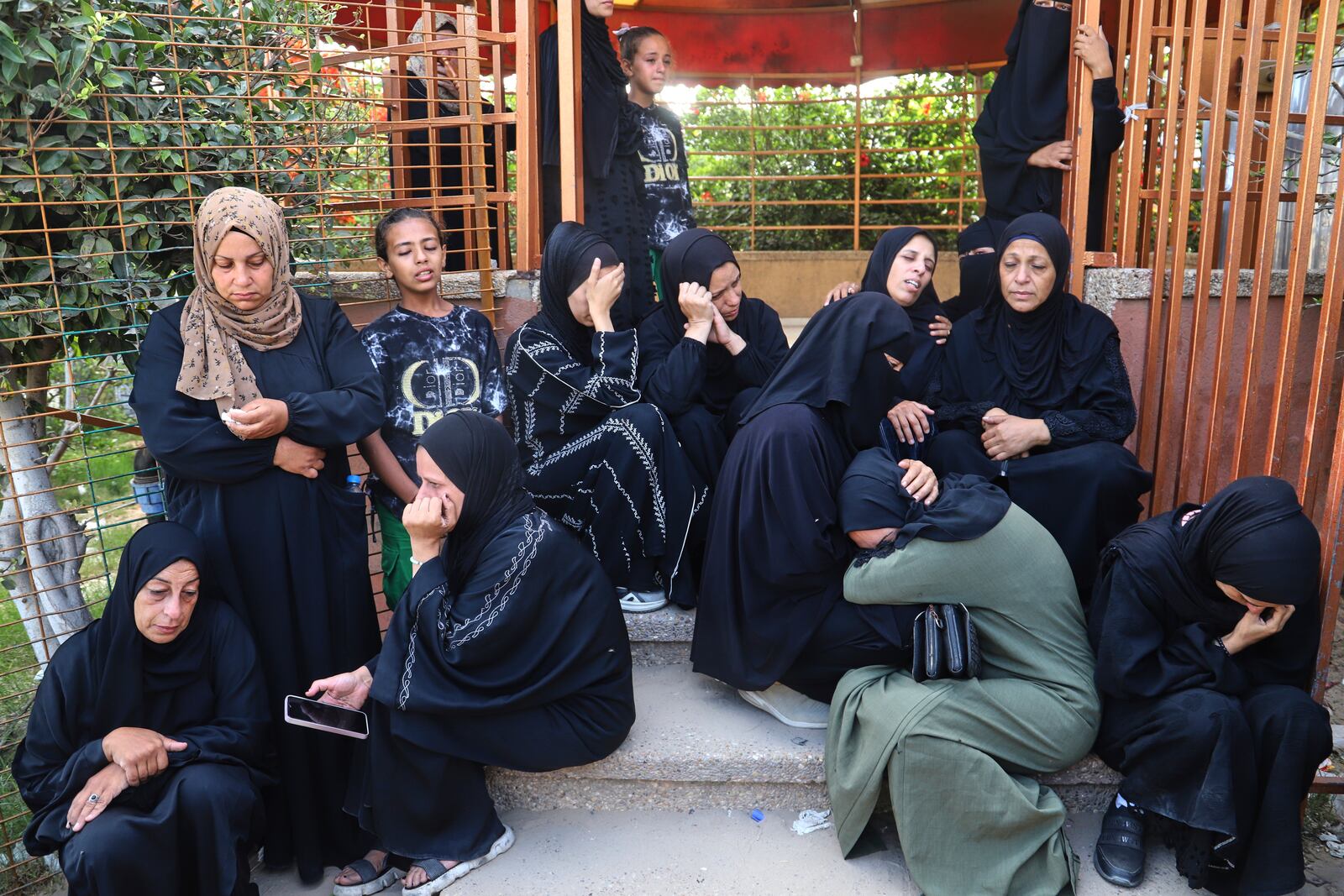 Palestinian women mourn for the relatives killed in an Israeli strike, at Nasser Hospital in Khan Younis, southern Gaza Strip, Tuesday, June 17, 2025. (AP Photo/Mariam Dagga)