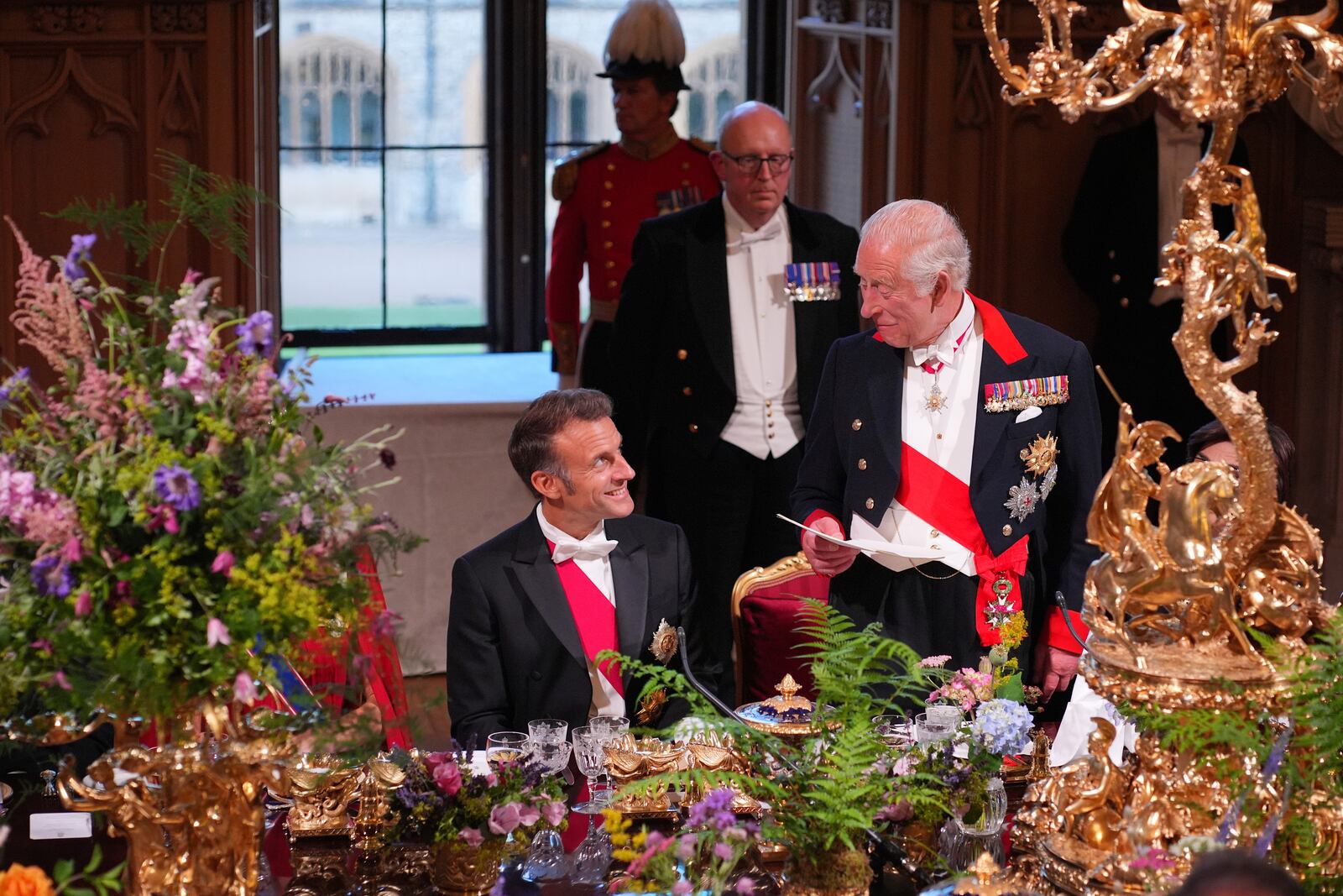 Britain's King Charles III speaks at the State Banquet for President of France Emmanuel Macron, left, and his wife Brigitte Macron, at Windsor Castle, in Windsor, England, Tuesday, July 8, 2025. (Yui Mok/Pool Photo via AP)