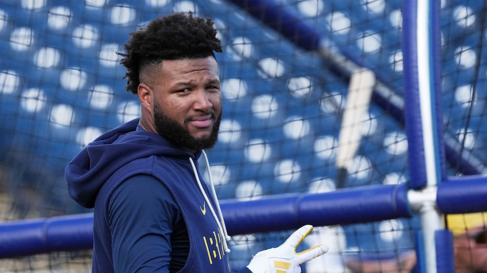 FILE - Milwaukee Brewers' Jackson Chourio gestures during a spring training baseball workout, Feb. 18, 2026, in Phoenix. (AP Photo/Morry Gash, File)
