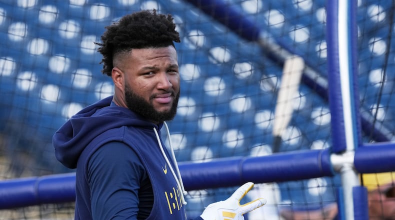 FILE - Milwaukee Brewers' Jackson Chourio gestures during a spring training baseball workout, Feb. 18, 2026, in Phoenix. (AP Photo/Morry Gash, File)