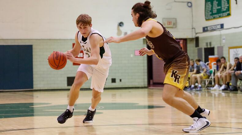 Catholic Central sophomore Tyler Galluch dribbles the ball while being guarded by Kenton Ridge senior Hunter White during their game on Wednesday night at Jason Collier Gymnasium in Springfield. The Irish won 69-41. Michael Cooper/CONTRIBUTED