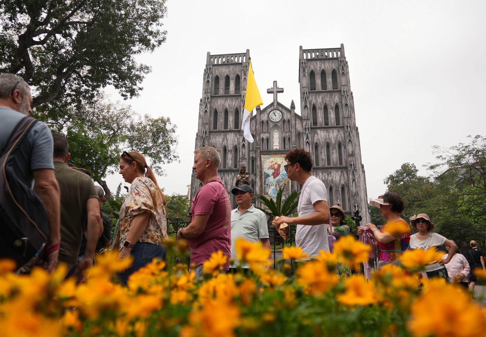 Tourists visit the St. Joseph's Cathedral in Hanoi, Vietnam, Tuesday, April 22, 2025. (AP Photo/Hau Dinh)