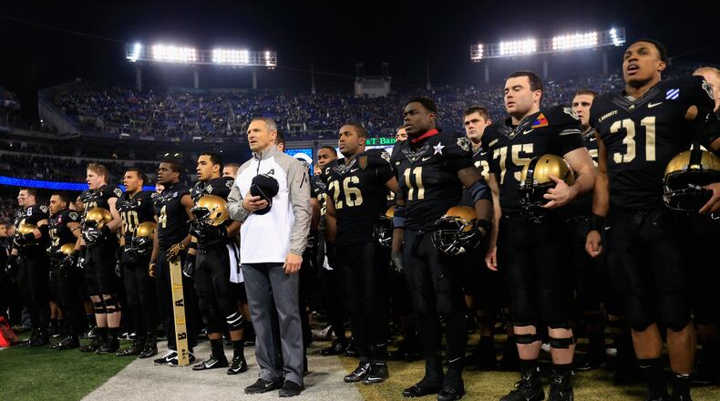 Head coach Jeff Monken of the Army Black Knights stands with his players and sings the teams fight song following their 17-10 loss to the Navy Midshipmen at M&T Bank Stadium on December 13, 2014 in Baltimore, Maryland. (Photo by Rob Carr/Getty Images)