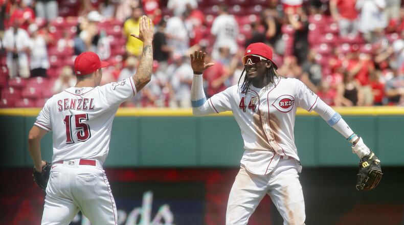 The Reds' Nick Senzel, left, and Elly De La Cruz elebrate a victory against the Colorado Rockies on Wednesday, June 21, 2023, at Great American Ball Park in Cincinnati. David Jablonski/Staff
