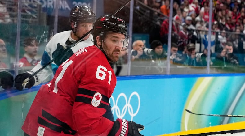 Canada's Mark Stone (61) challenges with Finland's Olli Maatta (3) during a men's ice hockey semifinal game between Canada and Finland at the 2026 Winter Olympics, in Milan, Italy, Friday, Feb. 20, 2026. (AP Photo/Hassan Ammar)