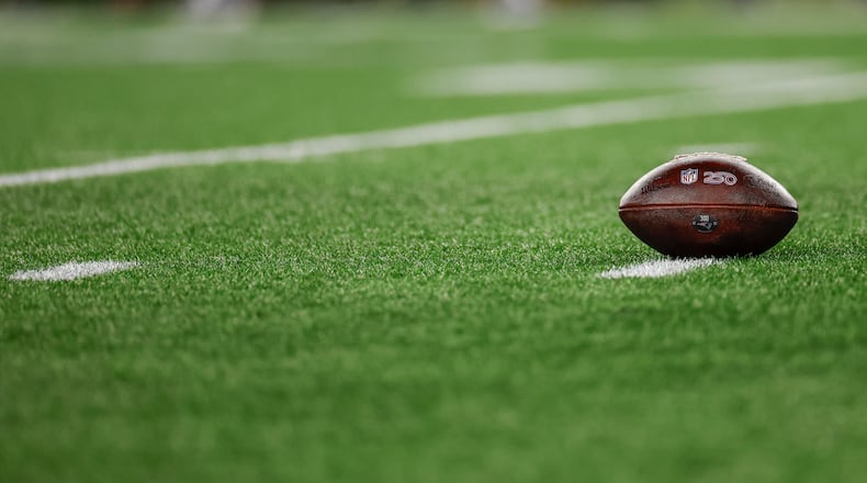 FILE - A football with the NFL shield logo rests on the turf during the second half of an NFL wild card playoff football game between the New England Patriots and the Los Angeles Chargers, Jan. 11, 2026, in Foxborough, Mass. (AP Photo/Greg M. Cooper, File)