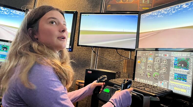 Oakwood High School student Lily Epley, 17, takes her turn on a flight simulator at the Lewis Jackson Airport in Greene County on Nov. 5. THOMAS GNAU/STAFF