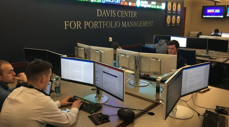 Students work in the University of Dayton’s Davis Center. Students in the center manage a $30-million stock portfolio for the university and regularly beat market benchmarks.