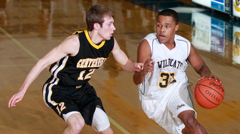 John Carson (32) of Springfield is guarded by Travis Feldmeyer (12) of Centerville during Tuesday's basketball game in Springfield on January 8, 2013.