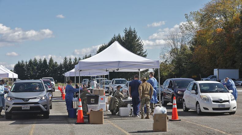 The Clark County Combined Health District holds a free drive-thru COVID-19 testing clinic in the parking lot of Kenton Ridge High School on Oct. 17. BILL LACKEY/STAFF