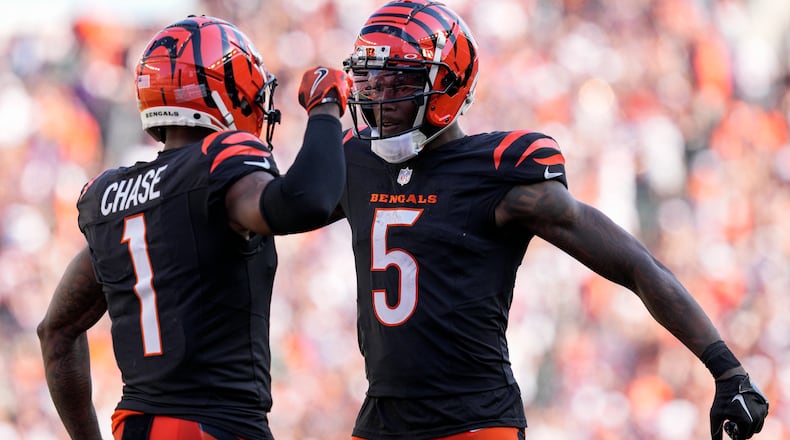Cincinnati Bengals wide receiver Ja'Marr Chase (1) celebrates his long touchdown reception with wide receiver Tee Higgins (5) during the second half of an NFL football game against the Baltimore Ravens, Sunday, Oct. 6, 2024, in Cincinnati. (AP Photo/Jeff Dean)