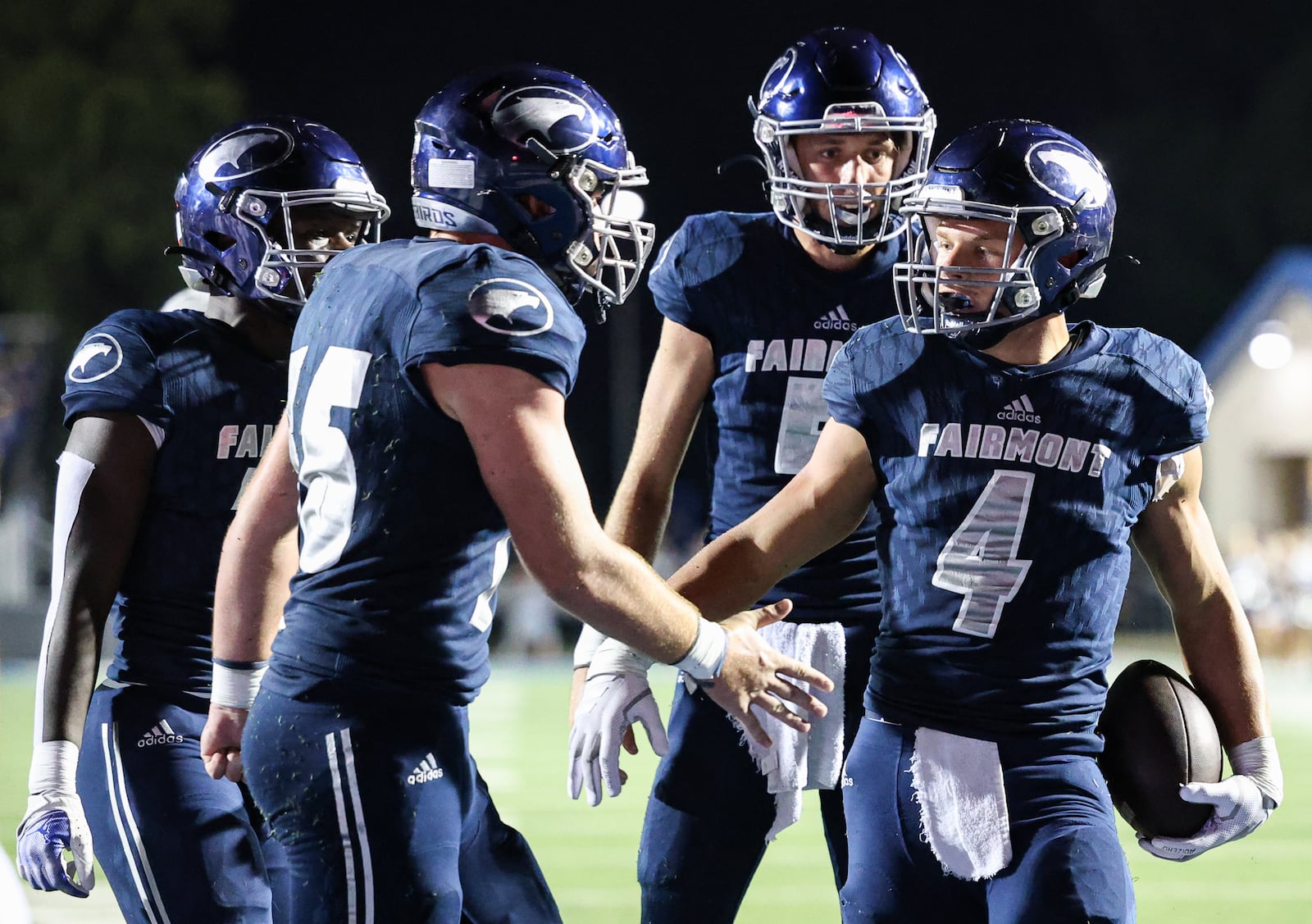 Fairmont senior running back Logan Doty celebrates with teammates after scoring a touchdown in the fourth quarter of a nonconference game against Trotwood-Madison on Friday, Aug. 29 at Roush Stadium in Kettering. BRYANT BILLING / STAFF