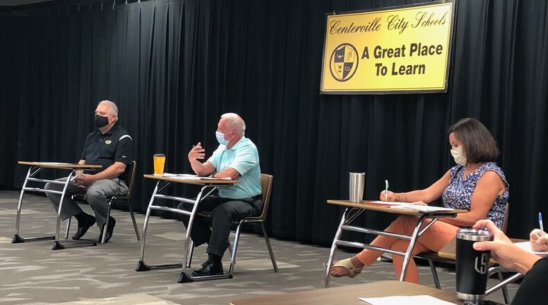 In a file photo, Centerville school board President John Doll, left, Superintendent Tom Henderson and school board member Allison Durnbaugh discuss restart plans for the 2020-21 school year Wednesday, Aug. 5, 2020 at Centerville High School.