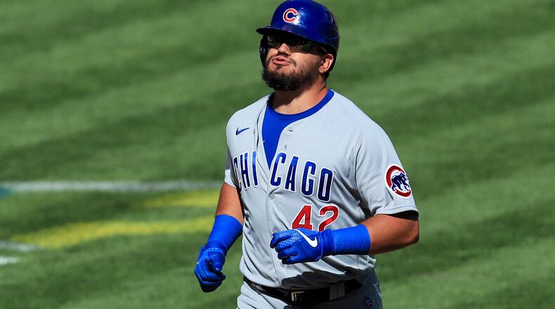 Chicago Cubs' Kyle Schwarber reacts after hitting a grand slam in the ninth inning during a baseball game against the Cincinnati Reds in Cincinnati, Sunday, Aug. 30, 2020. The Cubs won 10-1. (AP Photo/Aaron Doster)