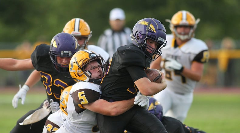 Kenton Ridge’s Michael Sloan tackles Mechanicsburg quarterback Aaron Conley in the second quarter on Friday, Aug. 30, 2019, in Mechanicsburg. David Jablonski/Staff