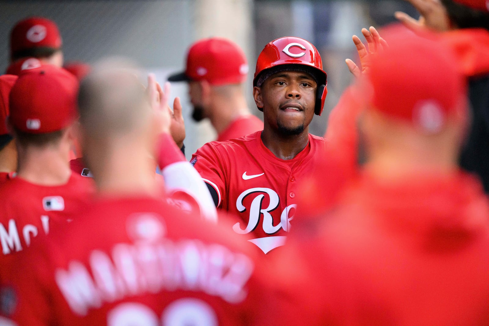 Cincinnati Reds' Ke'Bryan Hayes is greeted by teammates after scoring during the third inning of a baseball game against the Los Angeles Angels Wednesday, Aug. 20, 2025, in Anaheim, Calif. (AP Photo/William Liang)