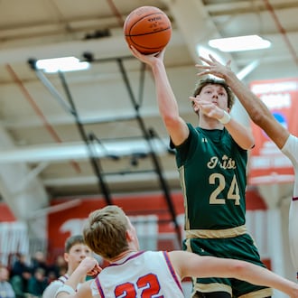 Catholic Central senior Keegan Guenther shoots the ball over Northwestern's Gabe Weinkauf during their game on Monday, Dec. 30, 2025 at Wittenberg University's Pam Evans Smith Arena. MICHAEL COOPER / STAFF