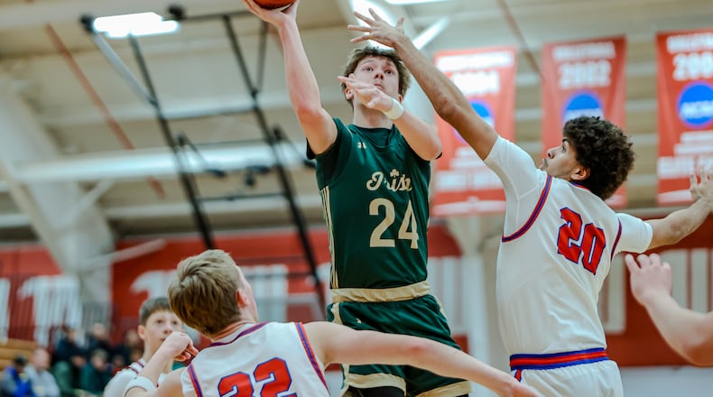Catholic Central senior Keegan Guenther shoots the ball over Northwestern's Gabe Weinkauf during their game on Monday, Dec. 30, 2025 at Wittenberg University's Pam Evans Smith Arena. MICHAEL COOPER / STAFF