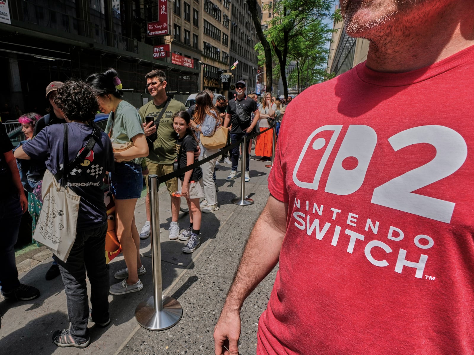 People wait in line outside the Nintendo store in New York's Rockefeller Center, Thursday, June 5, 2025. (AP Photo/Richard Drew)
