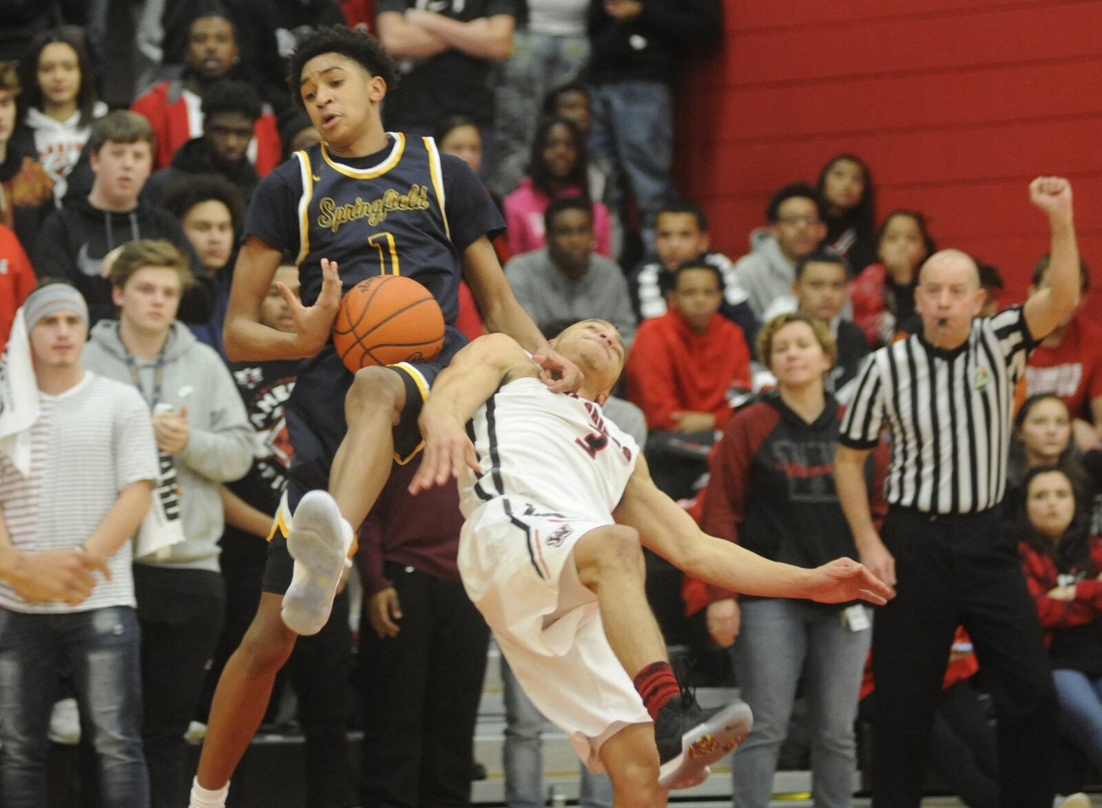 Springfield’s Sam towns (with ball) takes out Wayne’s Darius Quisenberry. Wayne defeated visiting Springfield 65-62 in OT in a boys high school basketball game on Wed., Jan. 24, 2018. MARC PENDLETON / STAFF