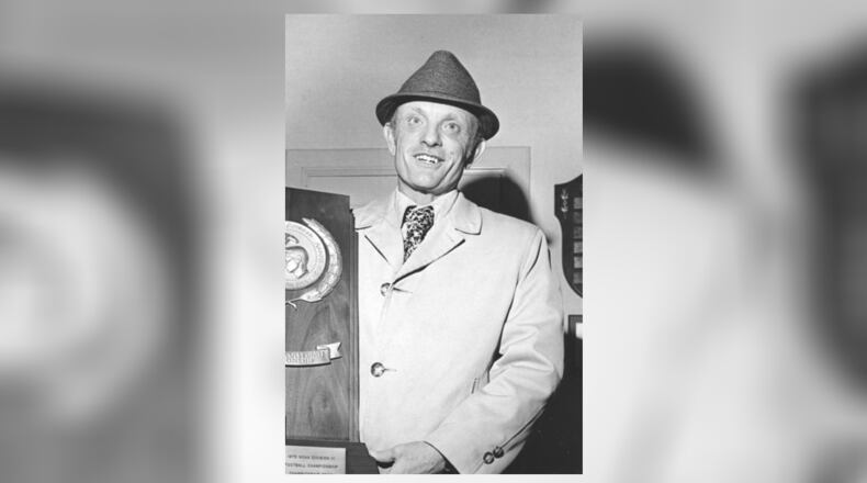 Wittenberg football coach Dave Maurer holds the NCAA Division III national championship trophy on Dec. 9, 1975. News-Sun file photo