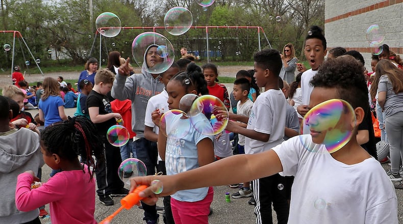 Students at Perrin Woods Elementary School celebrated Autism Awareness Month with a bubble blowing event on the school’s playground Wednesday. This was the fourth year the school has celebrated Autism Awareness Month with bubbles. BILL LACKEY/STAFF