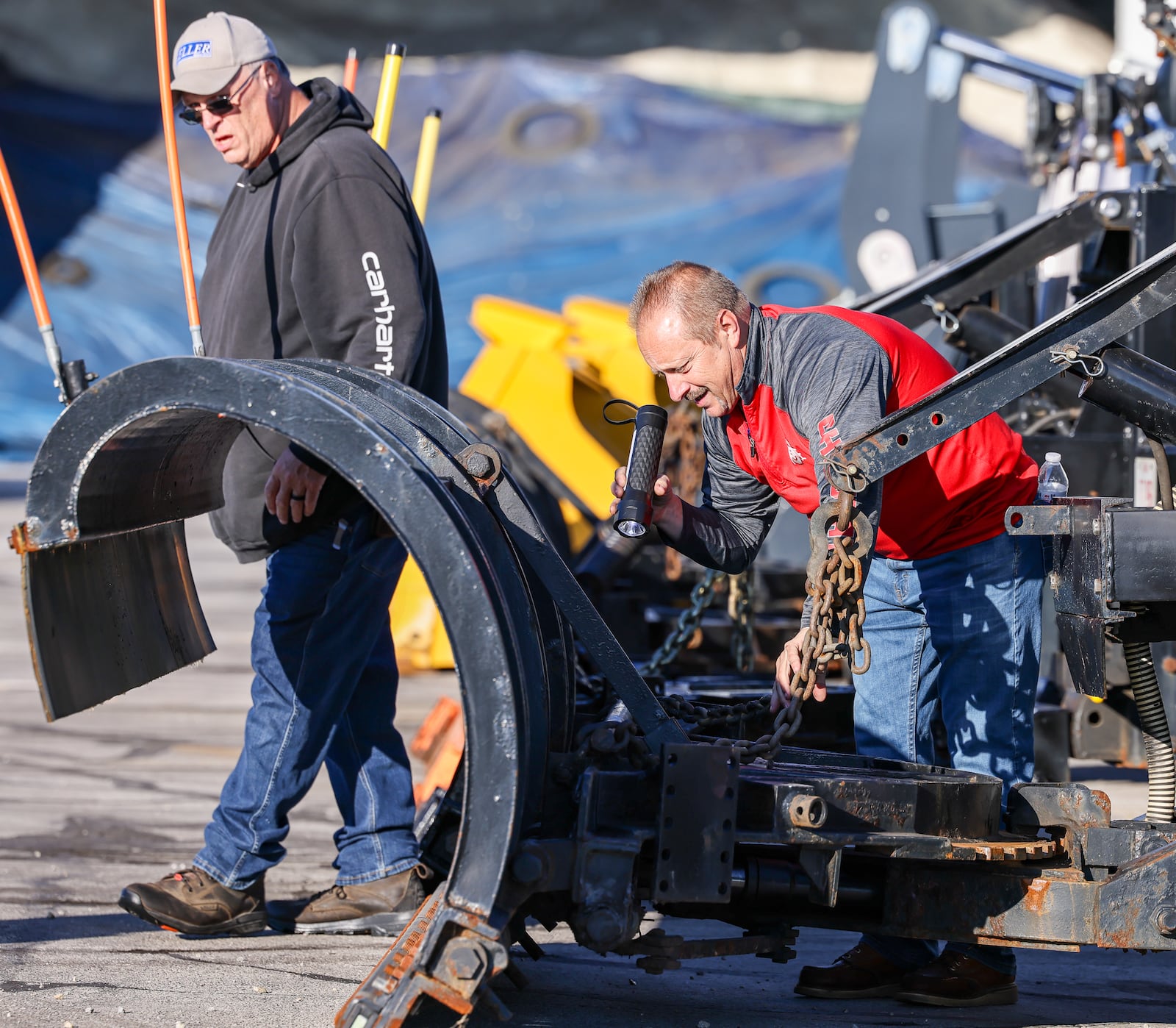 Ohio Department of Transportation workers inspect a truck used as a snow plow on Wednesday, Oct. 16  at the department's Montgomery County garage in Clayton. BRYANT BILLING / STAFF