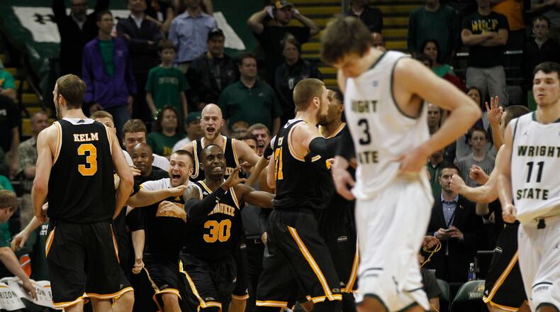 Milwaukee Panthers react as the clock ran out to defeat the Wright State Raiders 69-63 for the Horizon League Championship. Raiders Reggie Arceneaux and JT Yoho head for the locker room. TY GREENLEES / STAFF
