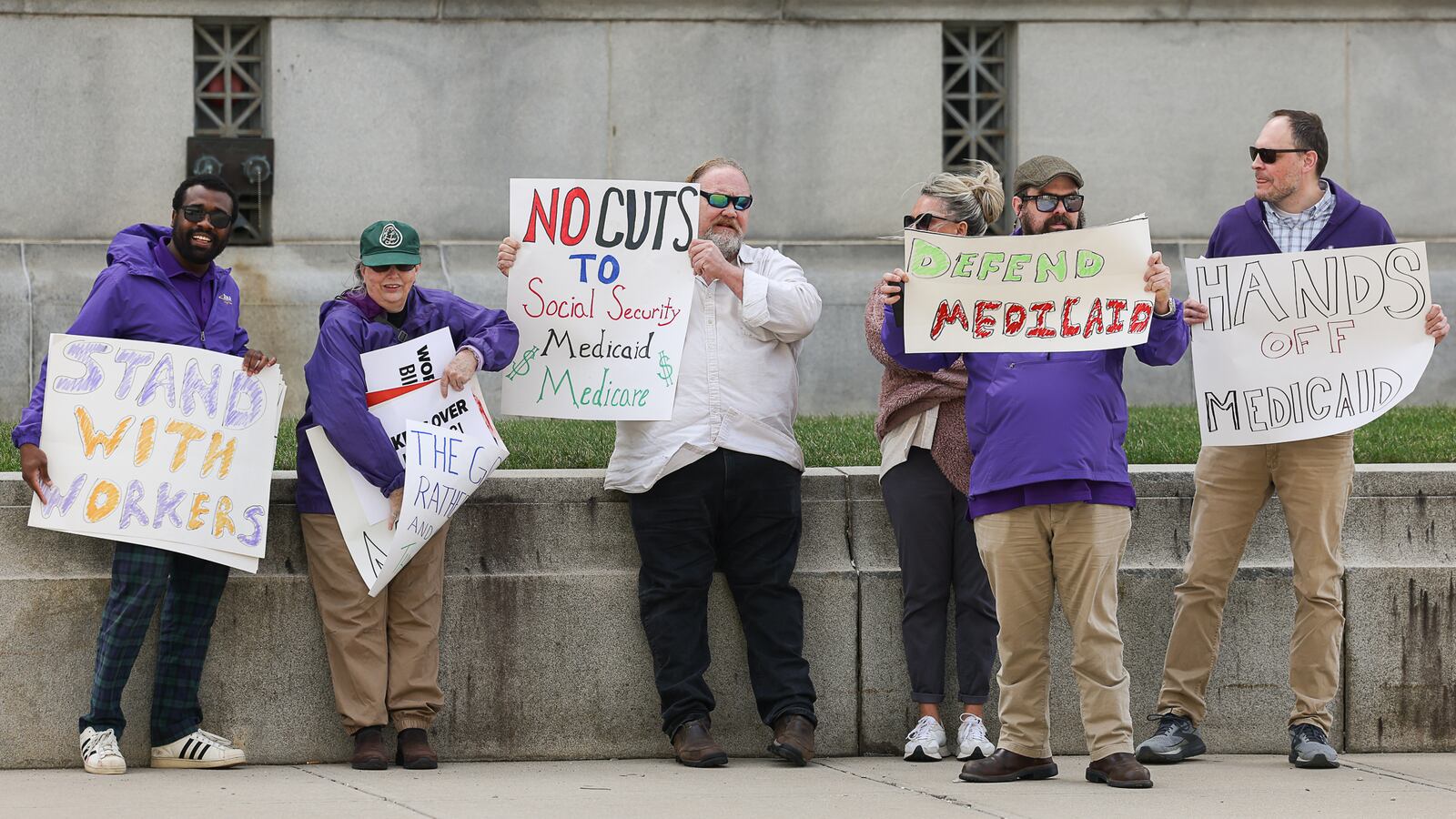 Members of SEIU 1199, a health care and social service union, demonstrate during a protest on Wednesday on West Third Street in downtown Dayton. The demonstrators were protesting in front of Rep. Mike Turner, R-Dayton, whose office is in the building that houses the United States Bankruptcy Court Southern District. BRYANT BILLING / STAFF