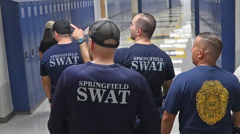 Members of the Springfield Police Division's SWAT team conduct a safety walk-through of Springfield High School Tuesday, August 9, 2022. BILL LACKEY/STAFF