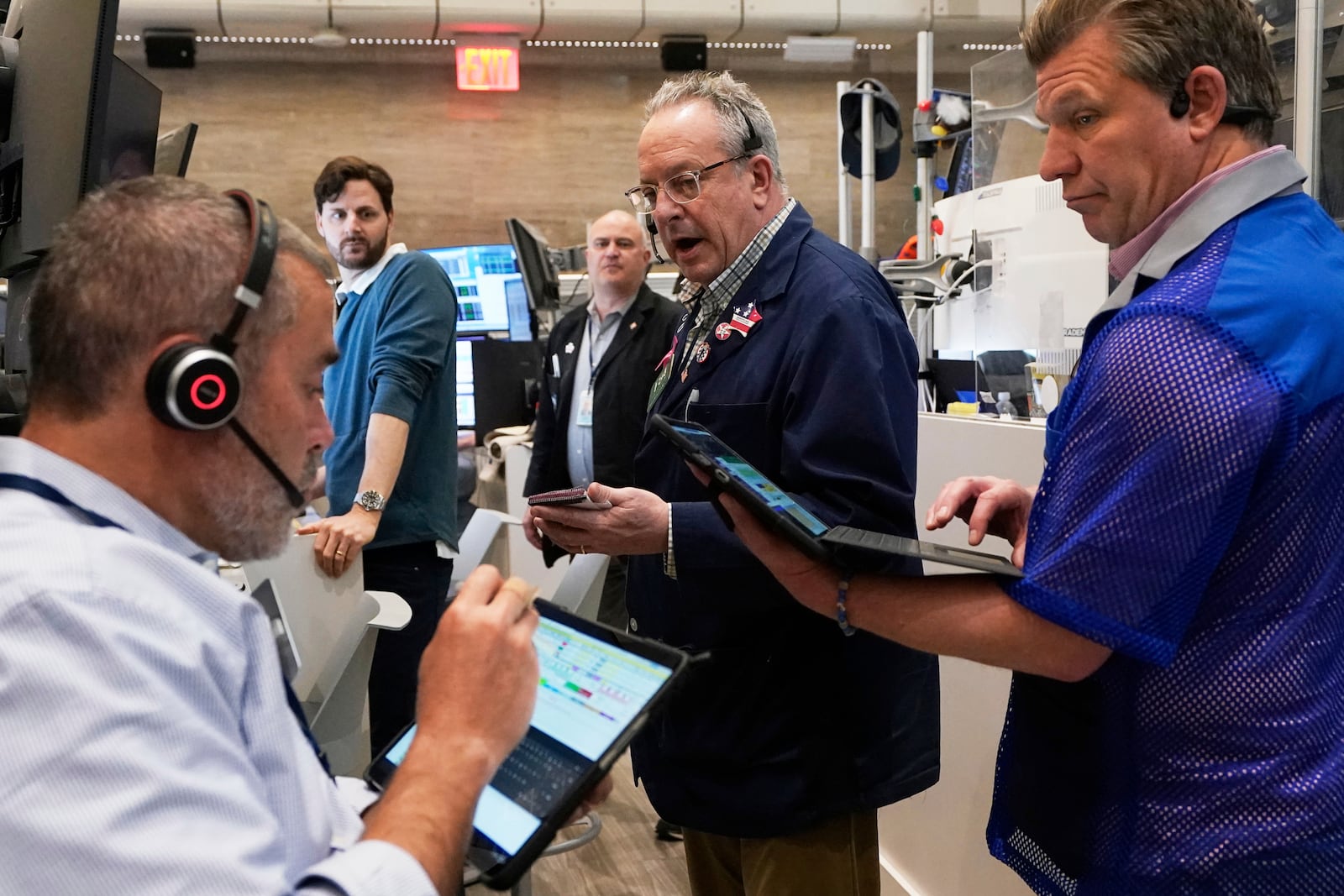 Phil Fracassini, center, works with fellow options traders on the floor of the New York Stock Exchange, Thursday, May 1, 2025. (AP Photo/Richard Drew)