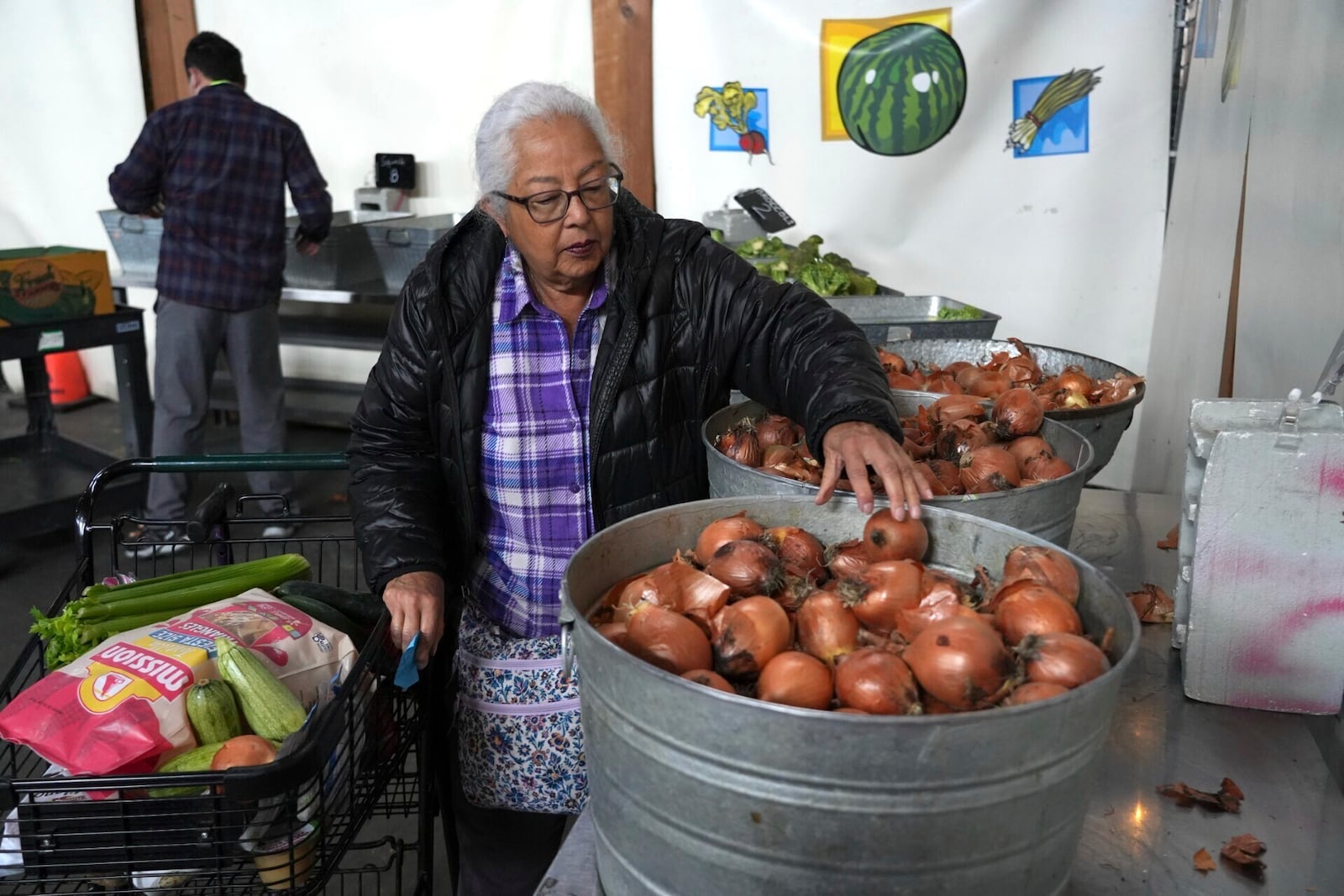 Alameda resident Beatriz Cortez picks up groceries at the Alameda Food Bank on Friday, April 25, 2025. (AP Photo/Terry Chea)
