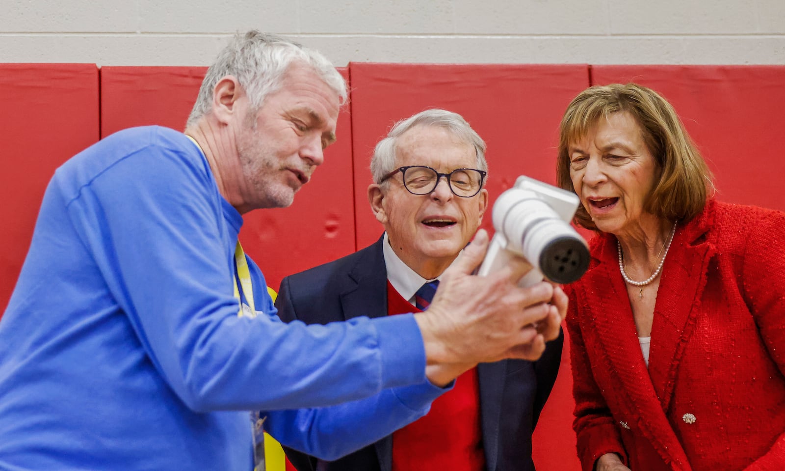 Don Engel, left, optical technician for Health Partners of Western Ohio, shows Ohio Gov. Mike DeWine, center, and First Lady Fran DeWine technology he uses to examine student's eyes as part of a new children's eyesight program, OhioSEE, at Northeastern Elementary School on Monday, Feb. 9, 2026, in South Vienna. JOSEPH COOKE/STAFF
